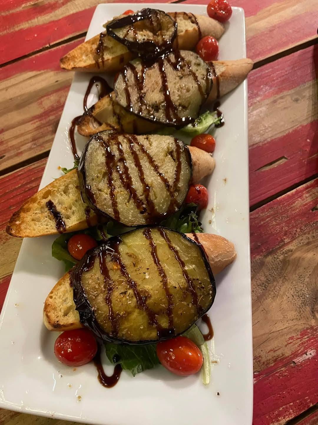 Eggplant bruschetta with balsamic reduction and cherry tomatoes
