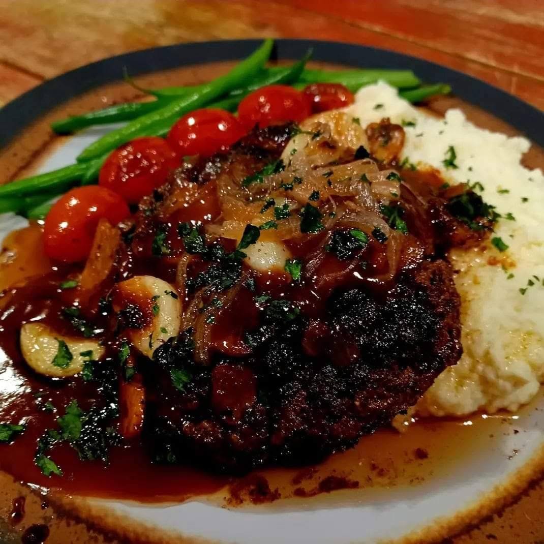 Chopped steak smothered in mushroom gravy and roasted garlic